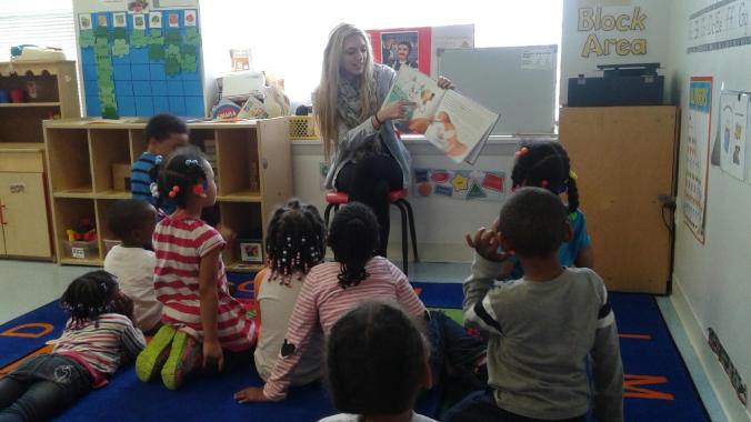 UDM student Alyssa Burgess reads with the kids at Emmanuel.
