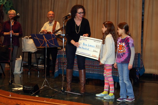 RX for Reading Executive Director Mary-Catherine Harrison awards the RX for Reading Prize.  Ann Arbor musicians Gemini and storyteller Laura Raynor were on hand for the celebration.