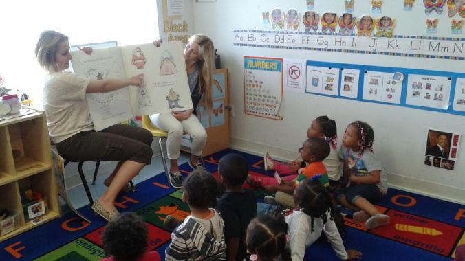 UDM undergraduates Emily Auten and Alyssa Burgess read with the kids at Emmanuel Head Start.