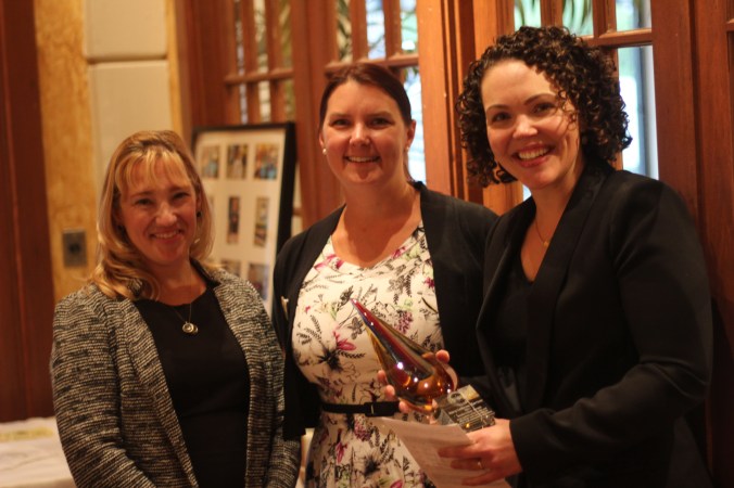 Mary-Catherine Harrison (right) after being presented the Bookwoman Award by Shannon Jones Janeczek (left), President of the WNBA Detroit Chapter and Tanya Davidson (middle), WNBA Detroit Award Chair.